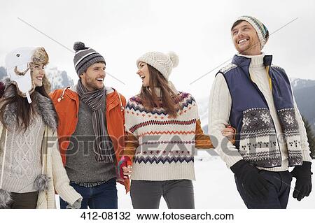 Happy friends walking in snow View Large Photo Image Stock Image - Happy friends walking in snow. Fotosearch