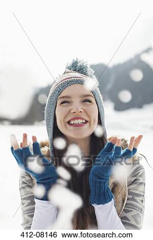Happy woman watching snow fall View Large Photo Image Stock Photograph - Happy woman watching snow fall. Fotosearch