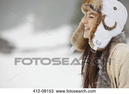 Happy woman wearing fur hat in snow View Large Photo Image Stock Image - Happy woman wearing fur hat in snow. Fotosearch