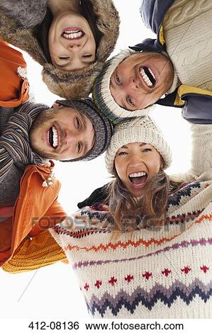 Low angle portrait of happy friends in huddle View Large Photo Image Stock Photograph - Low angle portrait of happy friends in huddle. Fotosearch