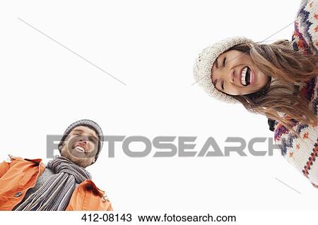 Stock Image - Low angle portrait of laughing couple. Fotosearch