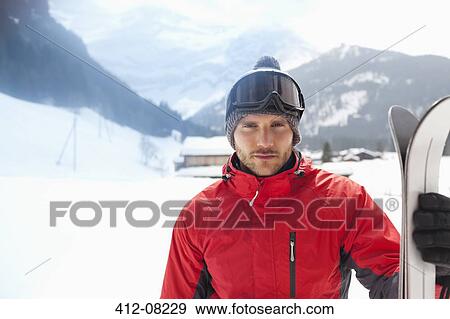 Portrait of confident man with skis in snowy field View Large Photo Image Stock Photo - Portrait of confident man with skis in snowy field. Fotosearch
