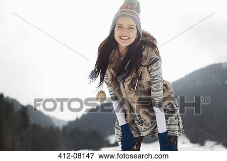 Stock Photo - Portrait of happy woman in snow. Fotosearch