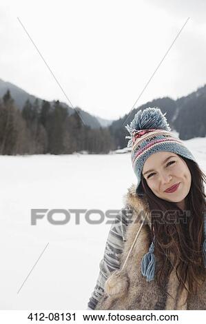 Portrait of smiling woman in snowy field View Large Photo Image Stock Image - Portrait of smiling woman in snowy field. Fotosearch