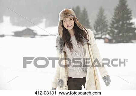 Portrait of smiling woman in snowy field View Large Photo Image Stock Image - Portrait of smiling woman in snowy field. Fotosearch