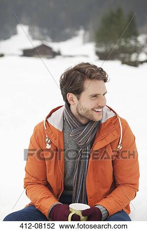 Smiling man drinking coffee in snowy field View Large Photo Image Stock Image - Smiling man drinking coffee in snowy field. Fotosearch
