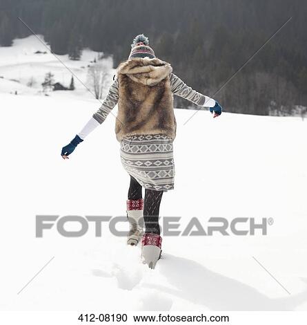 Woman walking in snowy field View Large Photo Image Stock Image - Woman walking in snowy field. Fotosearch
