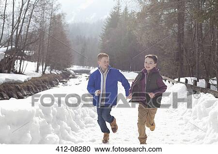 Boys holding hands and running in snowy lane View Large Photo Image Stock Image - Boys holding hands and running in snowy lane. Fotosearch