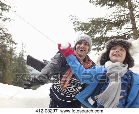 Father and son enjoying snowball fight View Large Photo Image Stock Photo - Father and son enjoying snowball fight. Fotosearch