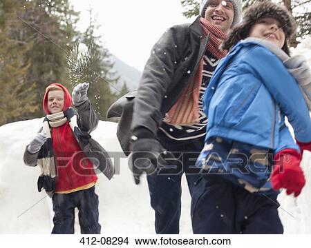 Picture - Father and sons enjoying snowball fight. Fotosearch