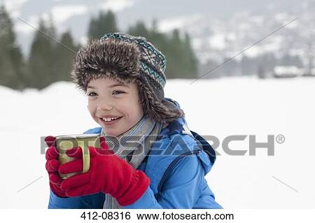 Happy boy drinking hot chocolate in snowy field View Large Photo Image Stock Photograph - Happy boy drinking hot chocolate in snowy field. Fotosearch
