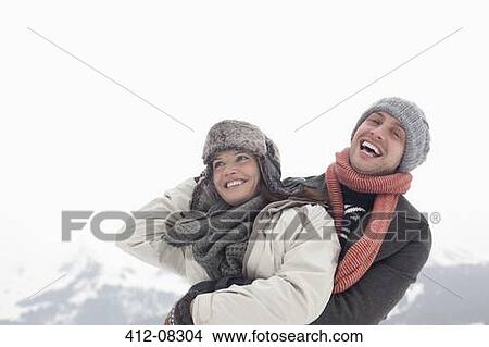 Happy couple hugging with mountain in background View Large Photo Image Picture - Happy couple hugging with mountain in background. Fotosearch