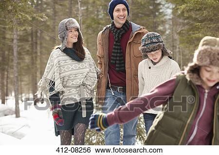 Happy family pulling Christmas tree in snow View Large Photo Image Stock Photograph - Happy family pulling Christmas tree in snow. Fotosearch