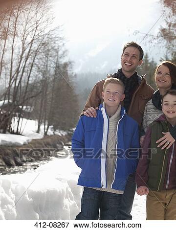 Happy family standing in snow View Large Photo Image Stock Photo - Happy family standing in snow. Fotosearch
