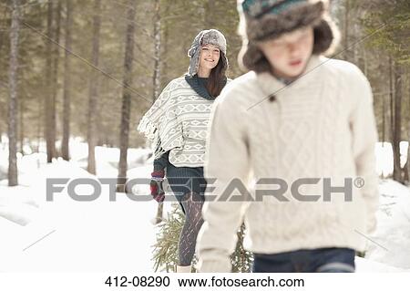 Mother and son dragging fresh Christmas tree in snowy woods View Large Photo Image Stock Image - Mother and son dragging fresh Christmas tree in snowy woods. Fotosearch