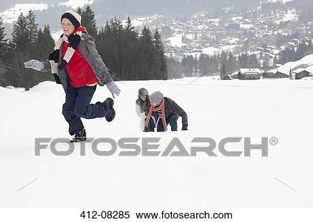 Mother and sons playing in snowy field View Large Photo Image Stock Photography - Mother and sons playing in snowy field. Fotosearch
