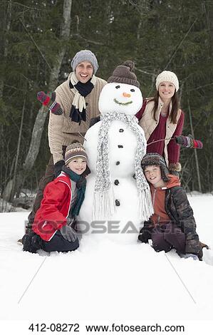 Portrait of happy family with snowman View Large Photo Image Stock Image - Portrait of happy family with snowman. Fotosearch