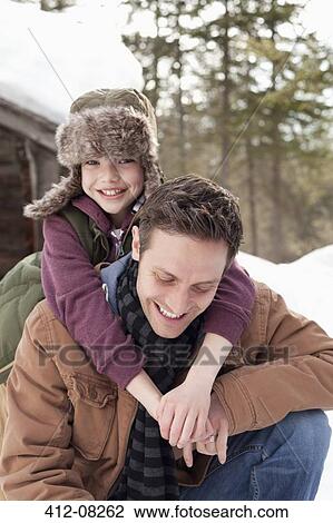 Portrait of happy son hugging father in snow View Large Photo Image Stock Image - Portrait of happy son hugging father in snow. Fotosearch
