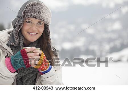 Portrait of happy woman in fur hat drinking coffee in snowy field View Large Photo Image Stock Image - Portrait of happy woman in fur hat drinking coffee in snowy field. Fotosearch