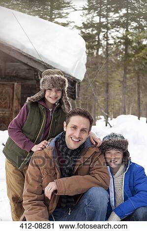 Portrait of smiling father and sons in snow outside cabin View Large Photo Image Stock Image - Portrait of smiling father and sons in snow outside cabin. Fotosearch