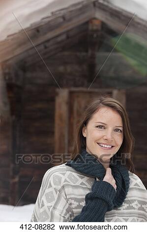 Portrait of smiling woman in snow outside cabin View Large Photo Image Stock Image - Portrait of smiling woman in snow outside cabin. Fotosearch