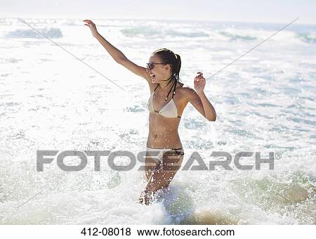 Enthusiastic woman splashing in ocean View Large Photo Image Stock Photo - Enthusiastic woman splashing in ocean. Fotosearch