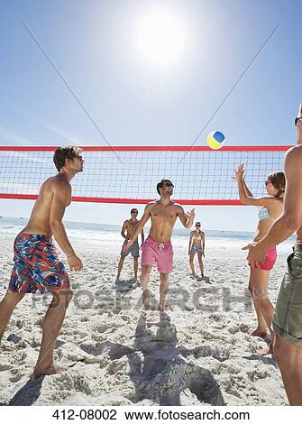 Friends playing beach volleyball View Large Photo Image Stock Image - Friends playing beach volleyball. Fotosearch