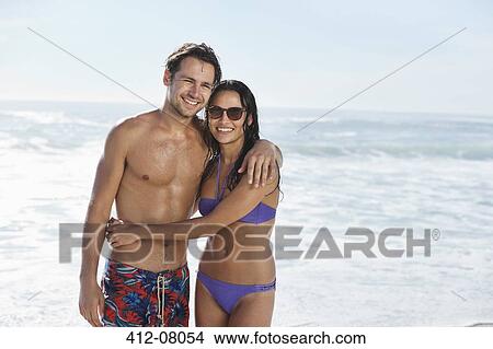 Picture - Happy couple hugging on beach. Fotosearch