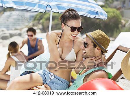Stock Photo - Happy couple hugging on beach. Fotosearch