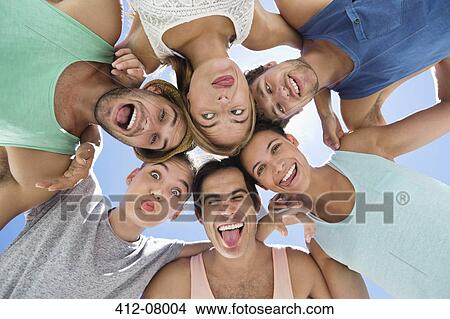 Low angle portrait of friends making silly faces View Large Photo Image Picture - Low angle portrait of friends making silly faces. Fotosearch