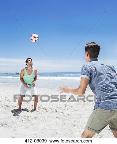 Man heading soccer ball on beach View Large Photo Image Stock Photo - Man heading soccer ball on beach. Fotosearch
