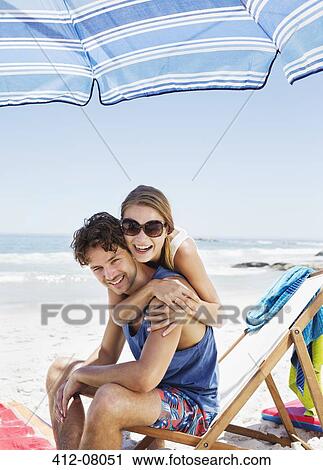 Portrait of happy couple hugging at beach View Large Photo Image Stock Image - Portrait of happy couple hugging at beach. Fotosearch