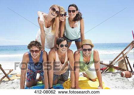 Portrait of happy friends forming pyramid on beach View Large Photo Image Stock Image - Portrait of happy friends forming pyramid on beach. Fotosearch