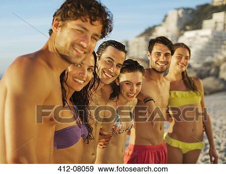 Portrait of happy friends in a row on beach View Large Photo Image Stock Photo - Portrait of happy friends in a row on beach. Fotosearch