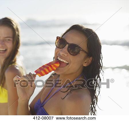 Portrait of happy woman enjoying flavored ice View Large Photo Image Stock Photo - Portrait of happy woman enjoying flavored ice. Fotosearch
