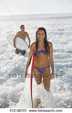 Portrait of smiling woman with surfboard in ocean View Large Photo Image Stock Image - Portrait of smiling woman with surfboard in ocean. Fotosearch