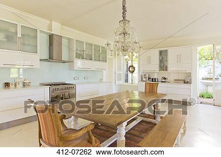 Chandelier over wooden table in kitchen View Large Photo Image Stock Image - Chandelier over wooden table in kitchen. Fotosearch