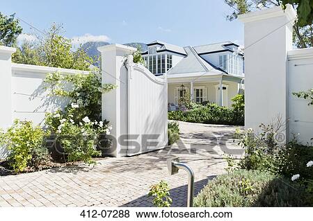 Driveway with open gate to luxury house View Large Photo Image Stock Photo - Driveway with open gate to luxury house. Fotosearch