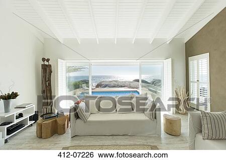 Living room overlooking swimming pool View Large Photo Image Stock Photograph - Living room overlooking swimming pool. Fotosearch