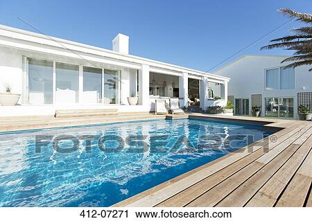 Stock Image - Luxury house and swimming pool. Fotosearch