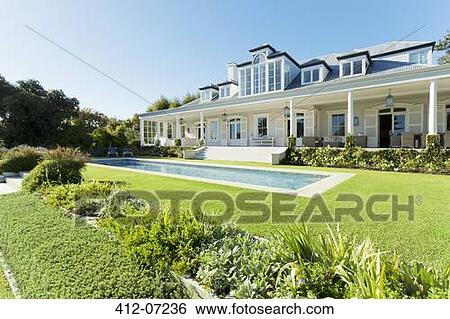 Stock Photograph - Luxury house facing swimming pool. Fotosearch