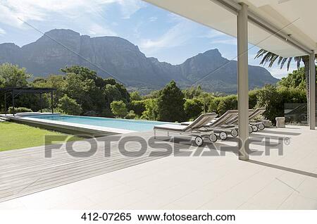 Luxury swimming pool with mountain view View Large Photo Image Stock Photography - Luxury swimming pool with mountain view. Fotosearch