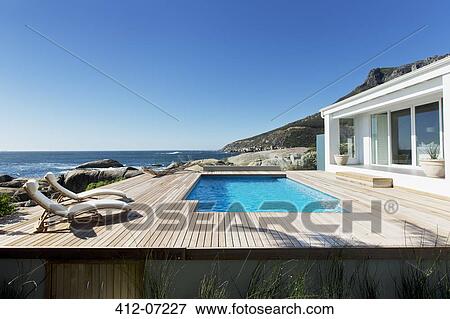Stock Photo - Luxury swimming pool with ocean view. Fotosearch