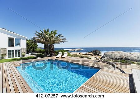 Stock Photo - Luxury swimming pool with ocean view. Fotosearch