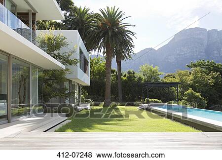 Stock Photo - Modern house and swimming pool . Fotosearch