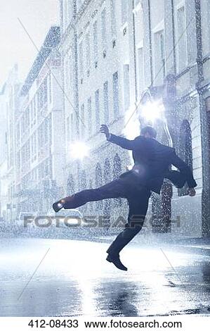Businessman dancing in rainy street View Large Photo Image Stock Image - Businessman dancing in rainy street. Fotosearch