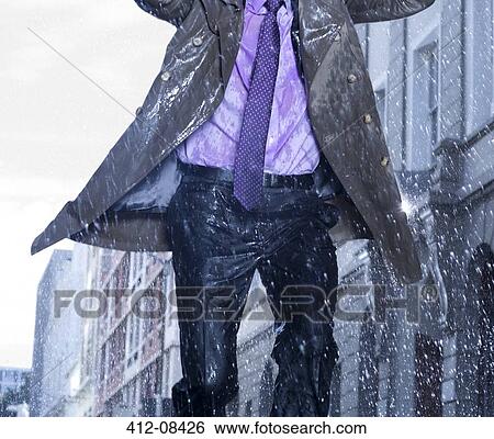 Businessman running in rain View Large Photo Image Stock Photograph - Businessman running in rain. Fotosearch