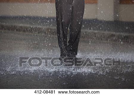 Businessman standing in rainy street View Large Photo Image Stock Image - Businessman standing in rainy street. Fotosearch