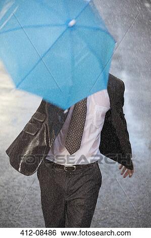 Businessman with tiny umbrella running in rainy street View Large Photo Image Stock Photograph - Businessman with tiny umbrella running in rainy street. Fotosearch