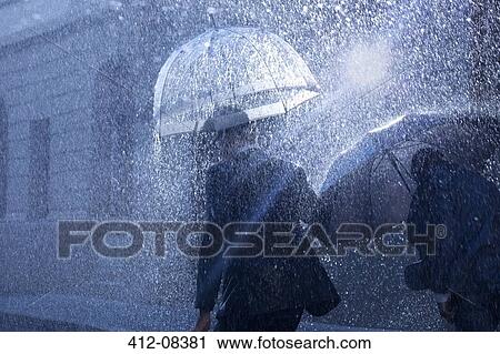 Businessmen with umbrellas in rain View Large Photo Image Stock Image - Businessmen with umbrellas in rain. Fotosearch
